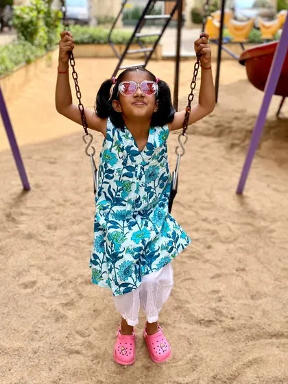 The pure joy of swinging high! I designed this 'Pakshi' (bird) print kurta to be versatile and fun. It's light enough for a warm day at the park and can be worn as a dress or paired with pants, making it a piece she'll reach for again and again.