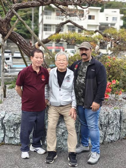 With my teachers in Okinawa. The wisdom passed down through generations is the bedrock of our school's teachings.