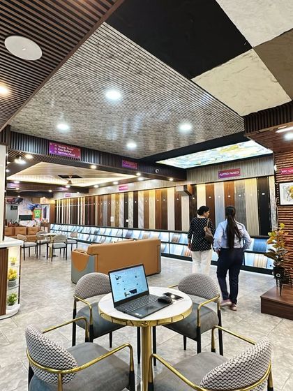 A laptop is open on our consultation table, ready to create a digital mockup for a client. We use technology to help you visualize your dream space.