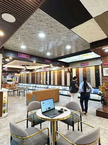 A laptop is open on our consultation table, ready to create a digital mockup for a client. We use technology to help you visualize your dream space.