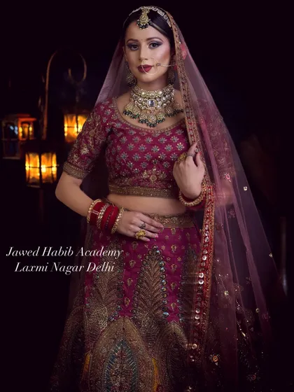 A classic bridal portrait showcasing a deep magenta lehenga and traditional jewelry. This is the kind of timeless, elegant work our students are trained to produce.