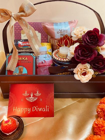 A full view of our premium leatherette basket hamper, brimming with snacks, flowers, and a diya for a complete Diwali celebration package.