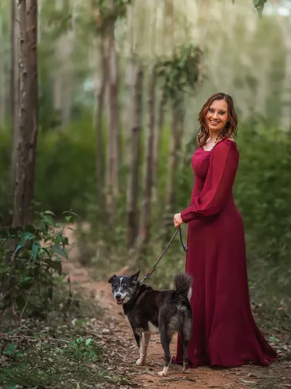 A duplicate of image 66, this portrait captures a woman and her dog in a tranquil forest setting. The composition, with the path leading through the trees, gives a sense of a shared journey, making it a beautiful metaphor for their life together.