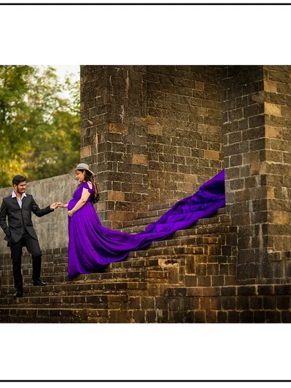 A fairy-tale-like shot on a stone staircase, with the long purple train of the gown creating a magical feel.