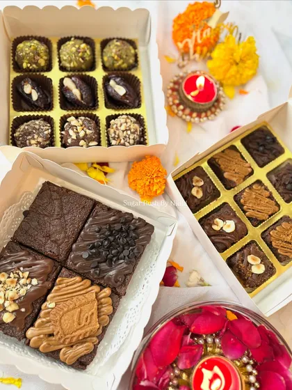 A flat lay of my various sweet boxes for Diwali. You can see the assorted brownie box, brownie bites box, and the Indian fusion sweet box.