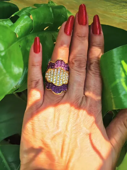 Make a bold statement with this Pave' diamond and ruby cocktail ring. The intricate design and vibrant stones make it a perfect accessory for festive occasions and parties.