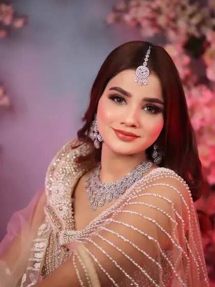 Another shot of our modern bride against a floral backdrop. The soft pink and purple lighting enhances the dreamy and romantic feel of the look.