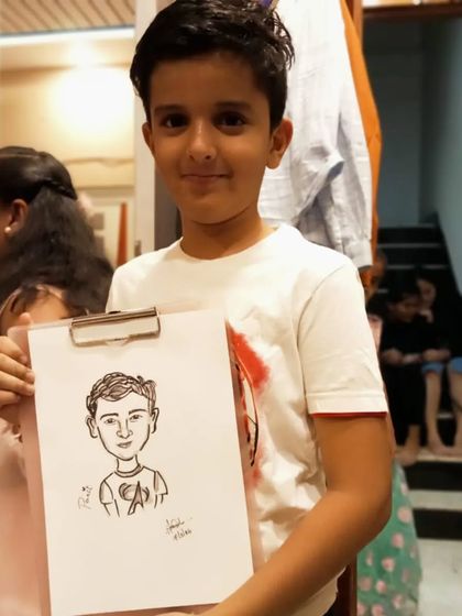 Panit posing with his sketch. It's a fun, interactive experience for kids at any party or event.
