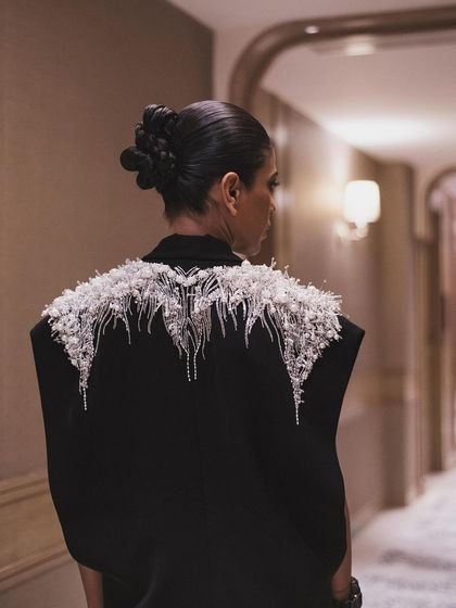 A view of the stunning, embellished shoulders of the Gaurav Gupta jacket. This detail shot showcases the artistry and craftsmanship of the designer piece.
