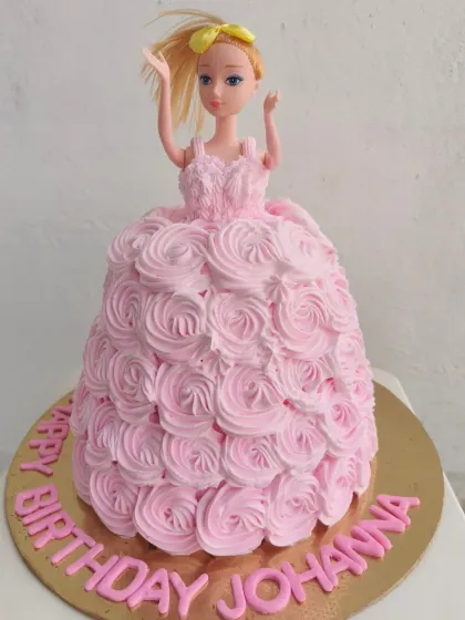 A classic Barbie doll cake, where the cake itself becomes her beautiful pink rosette gown. A dream cake for any Barbie fan.