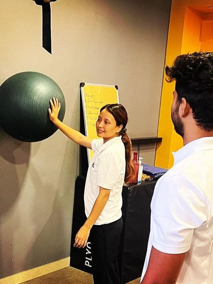Thutan demonstrating an exercise with a stability ball. Her athletic background gives her a unique insight into sports-related physiotherapy and training.