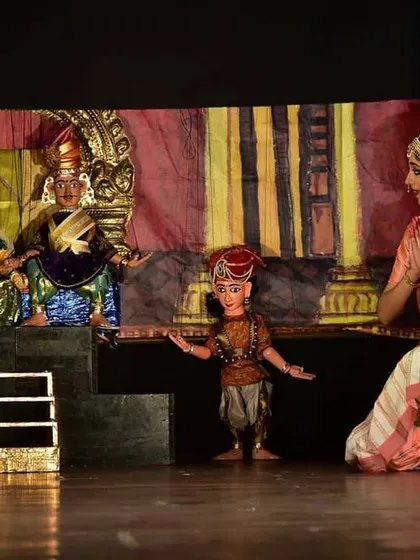 We often blend traditional string puppetry with classical dance, a unique fusion that brings a dynamic energy to our storytelling. In this scene from "Malavikaagnimitram," a live dancer interacts with the puppets, creating a beautiful dialogue between two distinct art forms. This combination allows for a richer, multi-layered performance.