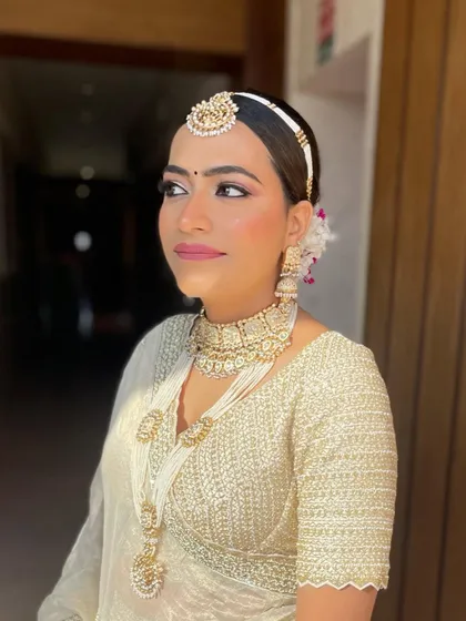 A beautiful portrait of the bride, where the floral bun adds a touch of softness to her overall look.