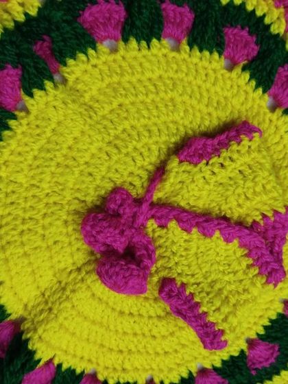 This woolen poshak features a bright yellow center with a pink and green border. The vibrant colors make it a happy addition to your Kanha Ji's winter wardrobe.