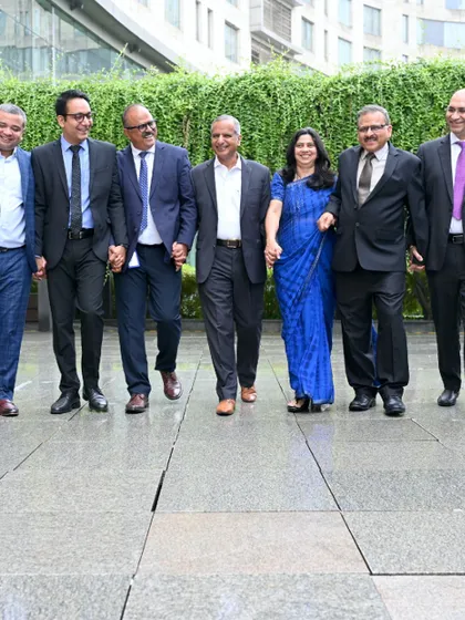 A dynamic, walking shot of a leadership team. This less formal approach to a group photo conveys forward-momentum, collaboration, and a modern corporate culture.