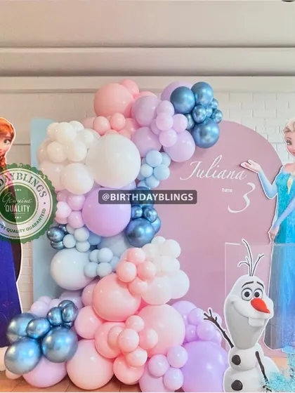 A sweet Frozen theme for a third birthday, with a pastel balloon garland and cutouts of Anna, Elsa, and Olaf. The soft color palette is perfect for younger children.