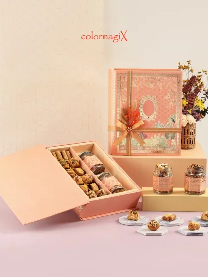 Our luxury book box hamper is a novel gifting idea. This elegant pink box opens like a book to reveal a selection of traditional sweets and jars of premium dry fruits.