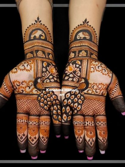 Symmetrical peacock designs for a guest. The bold, dark shading makes the motifs stand out against the lighter, detailed filler patterns.