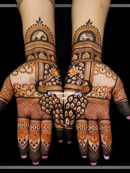 Symmetrical peacock designs for a guest. The bold, dark shading makes the motifs stand out against the lighter, detailed filler patterns.