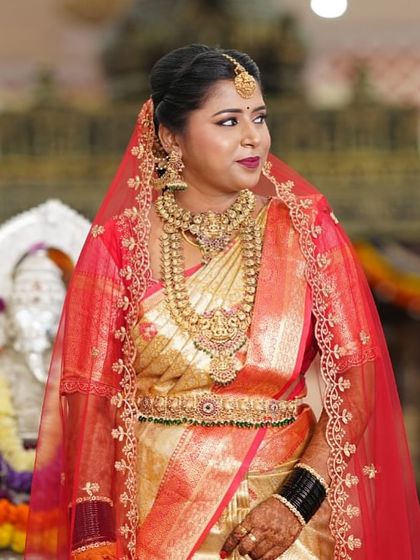 A regal portrait of our bride Uma. The complete set, from the maang tikka to the vaddanam, creates a look of timeless South Indian tradition and beauty.
