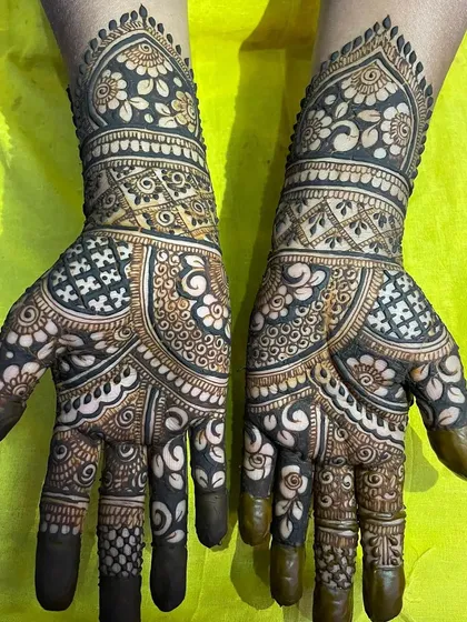A bold and beautiful design with heavy use of negative space and dark fills, creating a striking contrast on the hands.