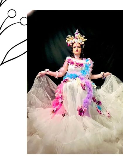 A full view of the unique white ruffle and feather gown. This is for the bride who wants a high-fashion, artistic look for her event or shoot.