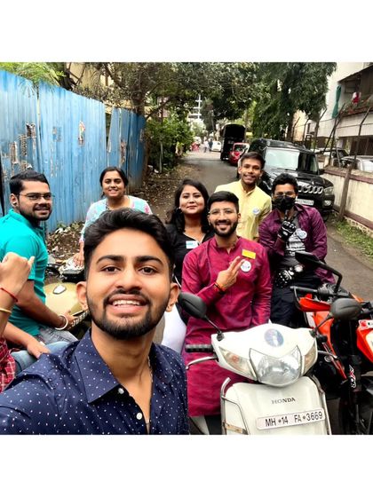 A duplicate of the group getting ready to explore Pune on scooters with the local Rotaract club members.