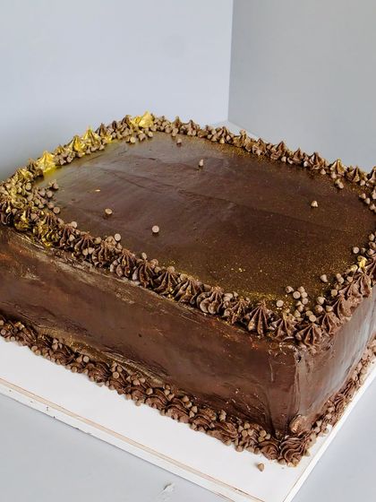 Keeping it classic for a corporate indulgence. This rich chocolate cake is layered with smooth ganache and a generous sprinkle of dark choco chips. It's simple, elegant, and irresistibly good.