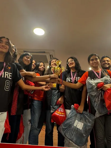 The joy of victory. Our girls' team celebrating together, holding up their championship trophy.