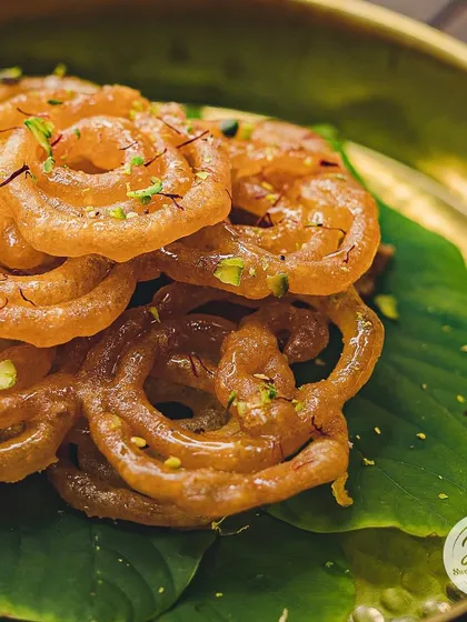 Barish ka mausam calls for some crispy Jalebi. Garnished with saffron and pistachios, these are the perfect treat to enjoy on a rainy day.