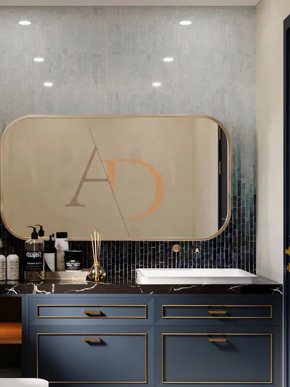 A close-up of a navy blue vanity with gold profile handles, set against a custom Kit Kat mosaic tile wall with a beautiful ombre effect.