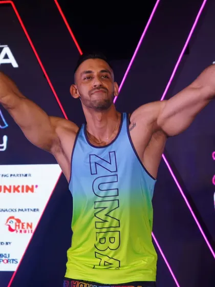 A moment of pure joy and accomplishment on stage after a massive Zumba party. This is the feeling we all share after giving it our all on the dance floor. The professional stage and lighting add to the festival atmosphere.