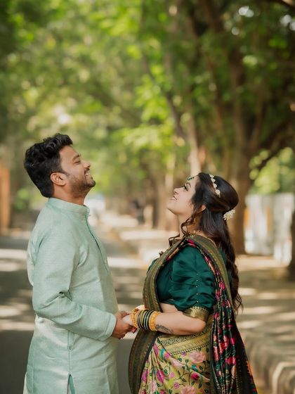 The couple looks up, sharing a moment of hope and happiness. This creative angle adds a unique and optimistic feel to their engagement portrait series.