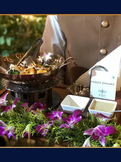 Another view of our Paneer Banjara appetizer station. The presentation, complete with fresh floral arrangements, demonstrates how we integrate our food service into your event's decor.