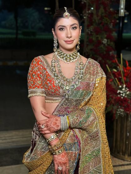 Creating a timeless look with a royal Indian touch. The soft, flawless makeup on this bride complements her traditional multi-colored lehenga and heirloom jewelry, making her feel like royalty on her special day.