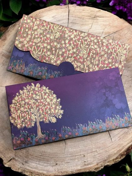A dreamy money envelope featuring a tree of life design against a purple twilight sky.