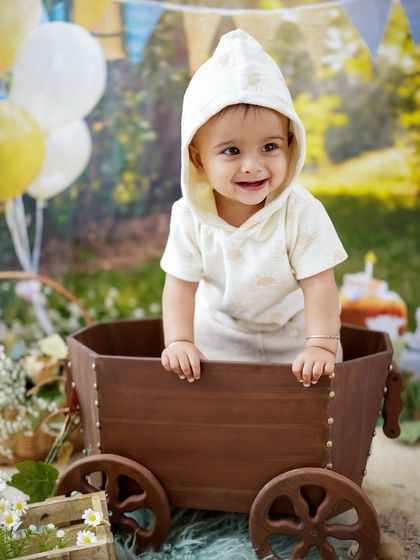 Another joyful shot from the rustic birthday session, with balloons in the background adding to the celebratory feel.