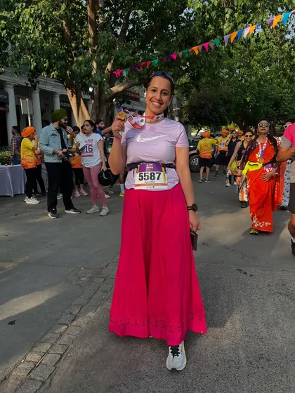 A runner proudly showing off her medal after the Vaisakhi 5K. The joy and sense of accomplishment after an event like this is what it's all about.