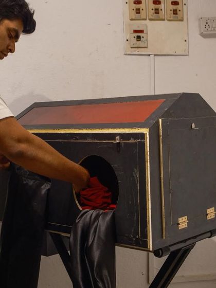 Inside the portable darkroom box, where the glass plate is sensitized just moments before the photograph is taken. This step must be done in complete darkness, relying entirely on touch.