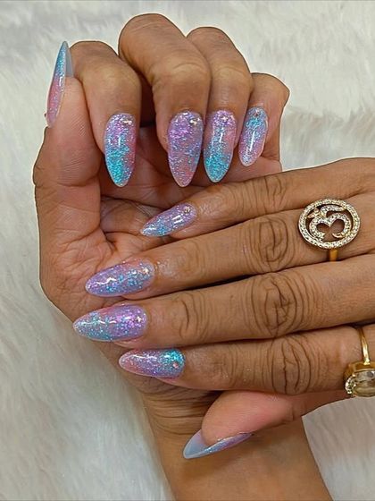 Catching the light and stealing the spotlight. These sparkling nails feature a beautiful iridescent glitter that shifts between pink, purple, and blue.
