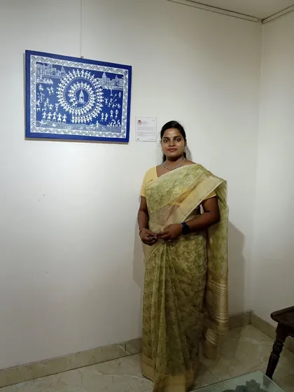 Here I am with my sold Warli painting. This tribal art form uses simple geometric shapes to depict scenes of community life, like the circular dance shown here.