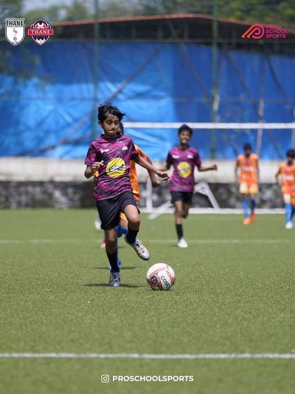 A player dribbles with determination, pushing the team forward.