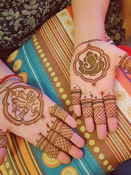 A simple and spiritual Ganesh Chaturthi design, with a Ganesha motif on one palm and a mantra on the other.