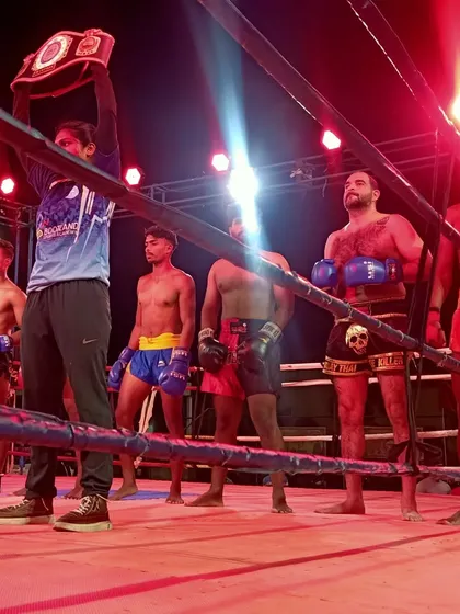 The pro division lineup, with champions holding their belts. This is the elite level we strive for.