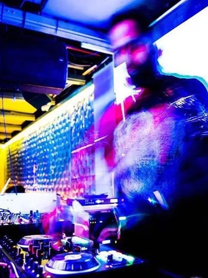 An abstract, long-exposure shot of me at the console. This image visually represents the blur of motion and energy that defines a great party.