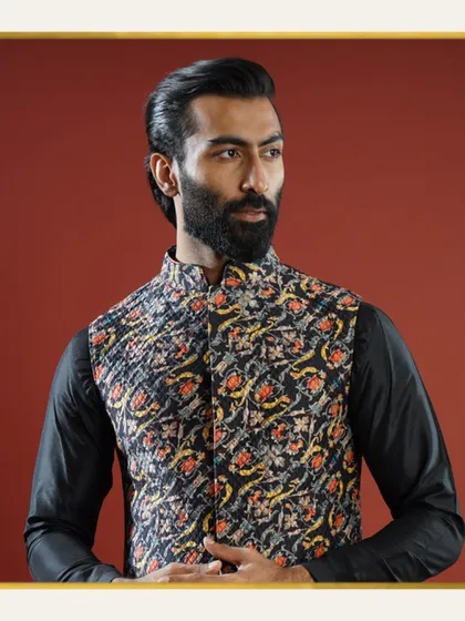 This black Jawahar jacket features a unique, abstract pattern in warm tones, offering a modern and artistic take on festive wear. It is an opulent ensemble that captures the spirit of celebration.