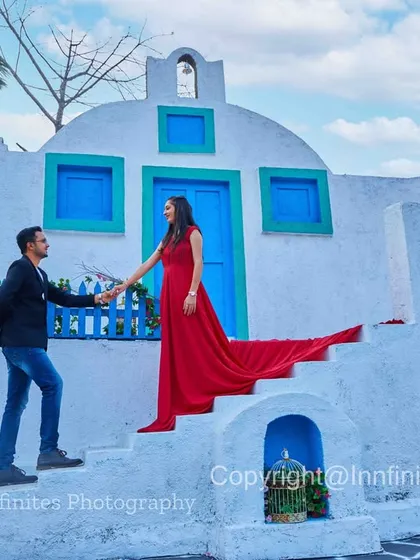 The long trail of a red gown adds a splash of color and drama to this shot on the steps of our Greek-style set.