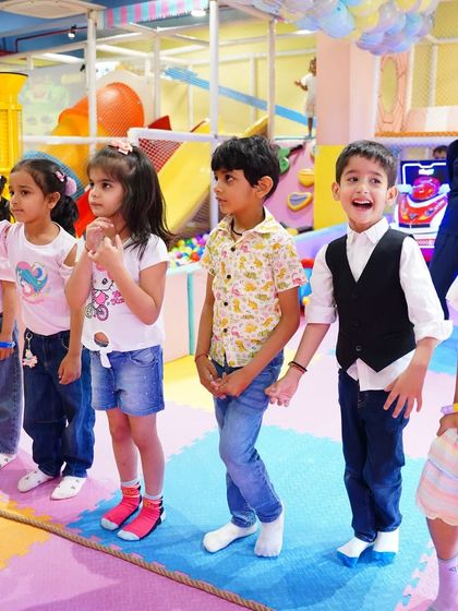Children line up for a game, their faces full of anticipation. Organized activities help structure the party and ensure everyone has a chance to play.