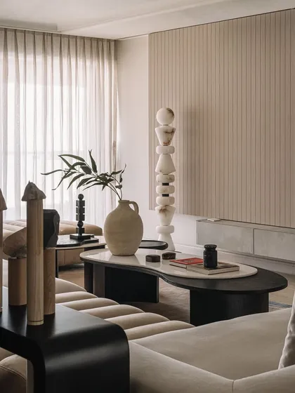 In the Kanso House living room, we created small stone totems from materials found on-site. Placed alongside a sculptural floor lamp, they add a layer of texture and a connection to the home's natural surroundings.