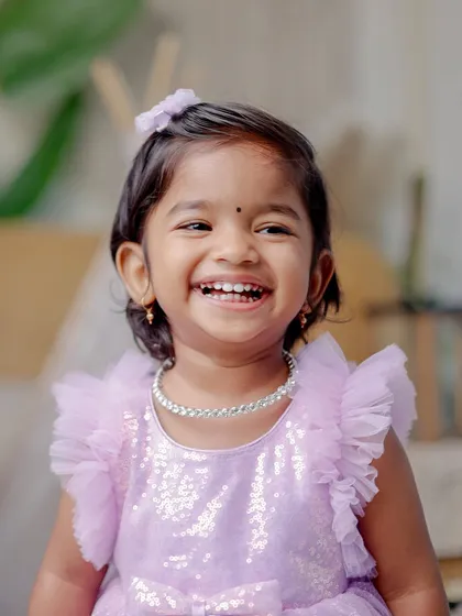 A close-up portrait of a toddler's infectious, happy laugh. This studio shot captures the genuine expression and personality of a young child, highlighting my ability to connect with kids and make them feel comfortable.